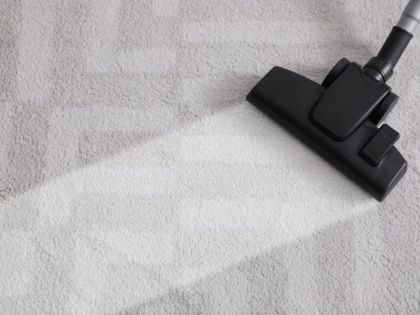 Vacuuming carpet. Clean area after using device, closeup