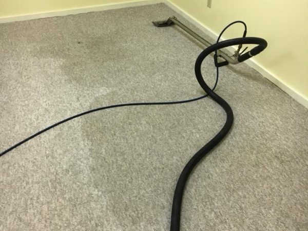 brown carpet in office space with carpet cleaning machine