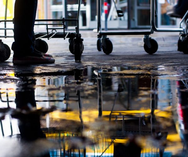 low-section-man-standing-by-shopping-carts (1)