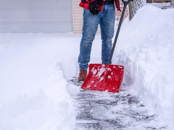 man shoveling snow after a winter storm