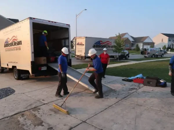 professionals doing fire restoration in driveway